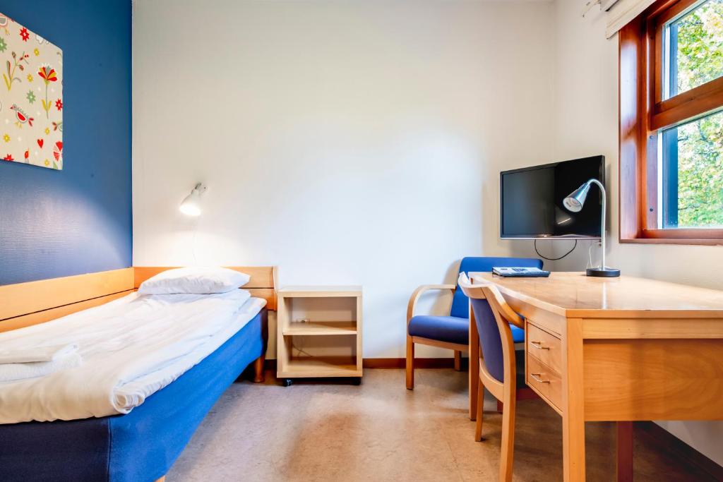 Postel nebo postele na pokoji v ubytování Västerbacken Hotell & Konferens