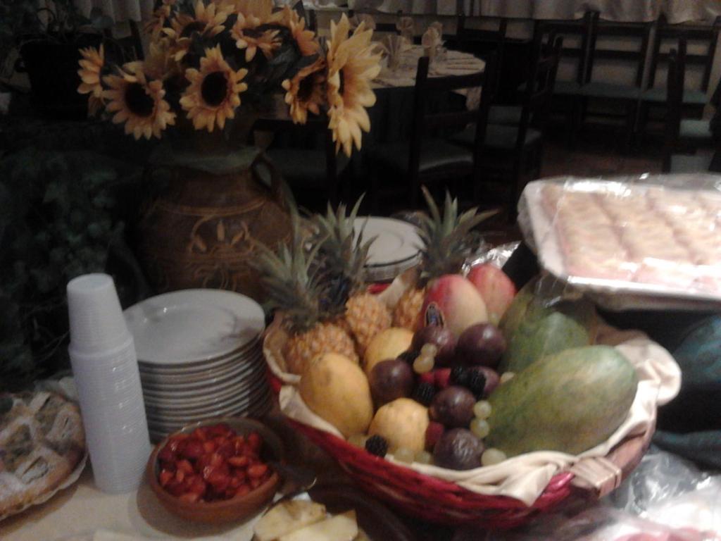 a table topped with a bowl of fruit and plates at Lo Scoiattolo in Castellafiume