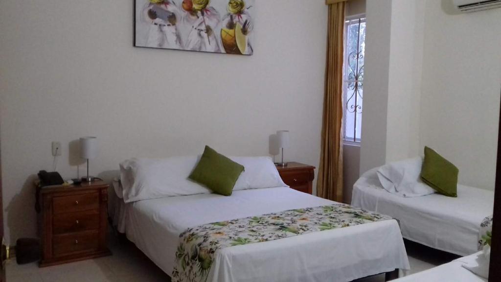 Postel nebo postele na pokoji v ubytování Hotel San Miguel Imperial