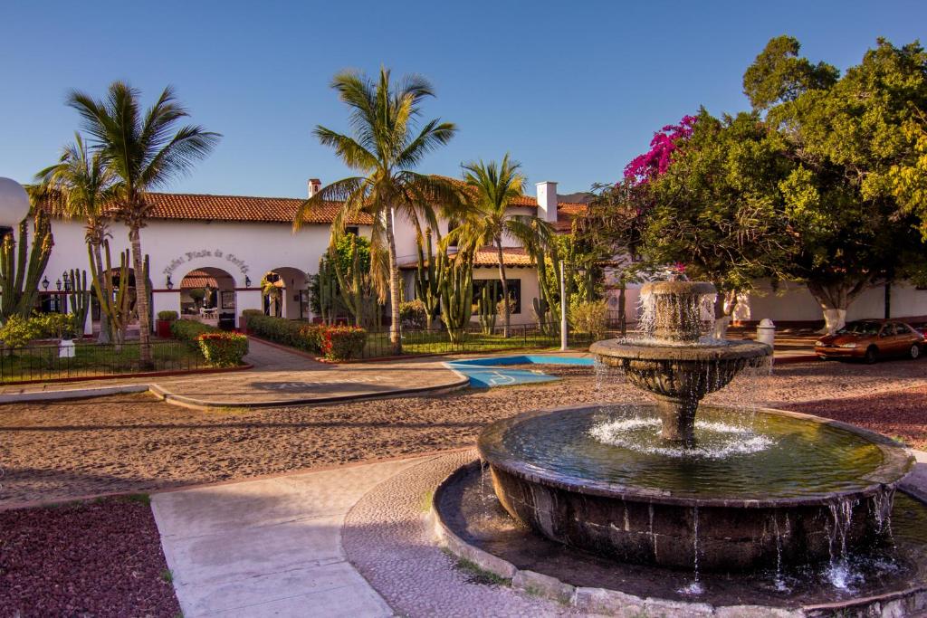 a fountain in a courtyard in front of a building at Hotel Playa de Cortes in Guaymas