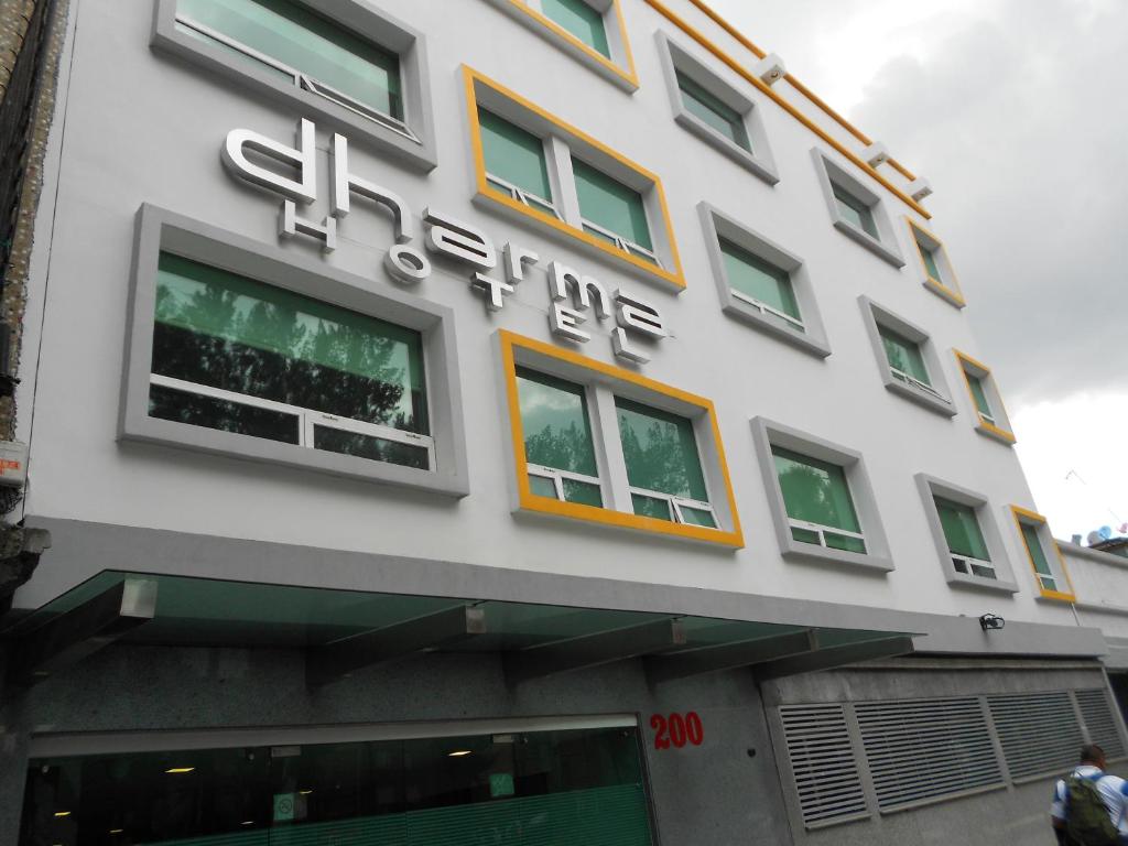 a building with a sign on the side of it at Hotel Dharma in Mexico City