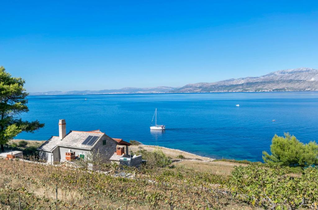 a house on the shore of a large body of water at House Svjetlana in Postira