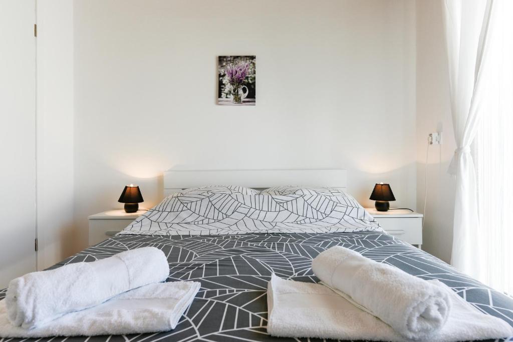 Łóżko lub łóżka w pokoju w obiekcie Diva Apartment