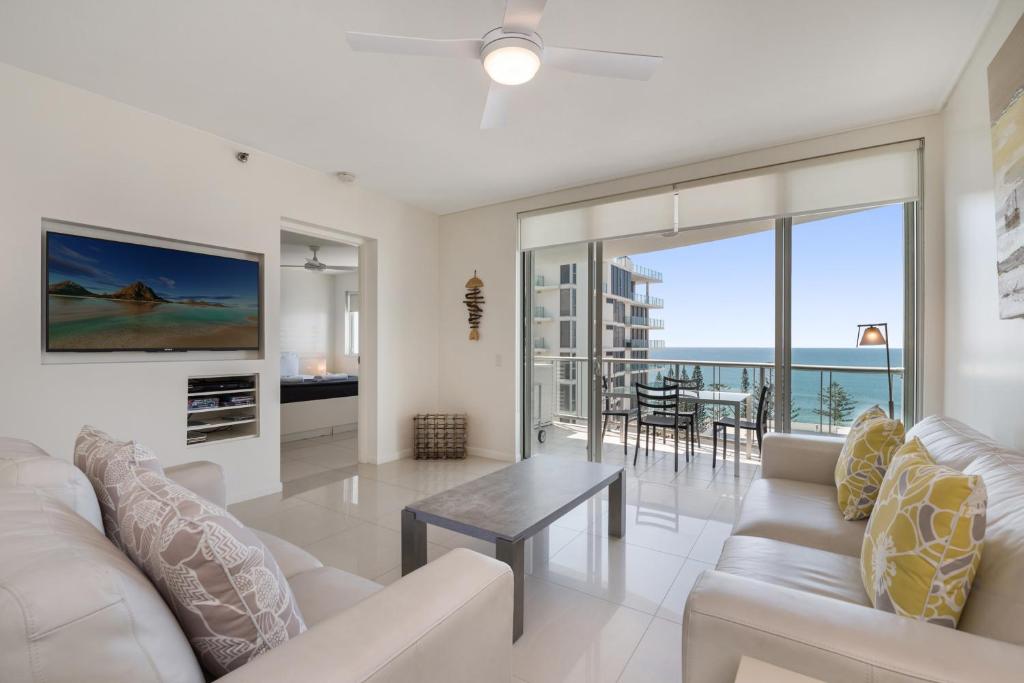 a living room with a couch and a table at Seamark on First in Mooloolaba