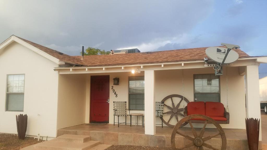 a small white house with a red door at La Casita in Phoenix