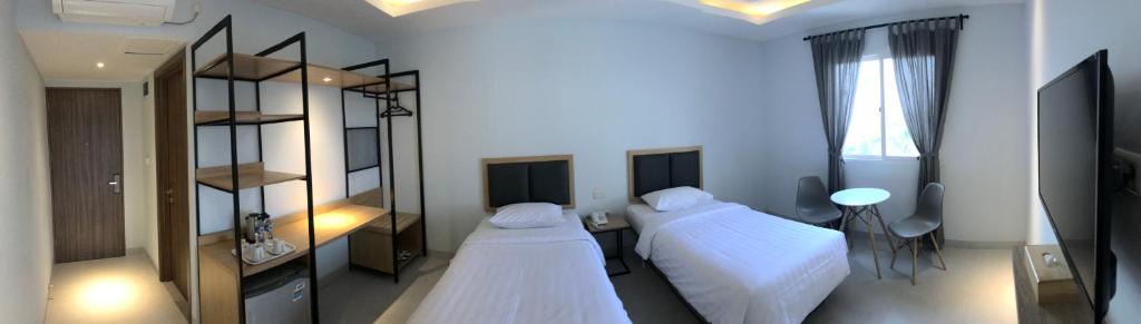 Postel nebo postele na pokoji v ubytování Hotel Arisu