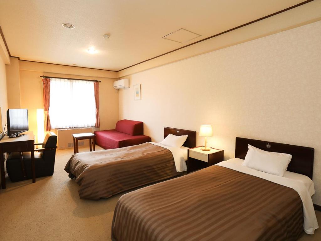 Postel nebo postele na pokoji v ubytování Shirakabako View Hotel