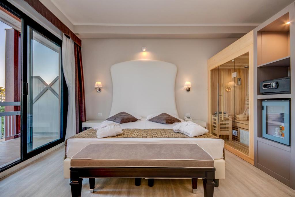 Postel nebo postele na pokoji v ubytování Hotel Oliveto