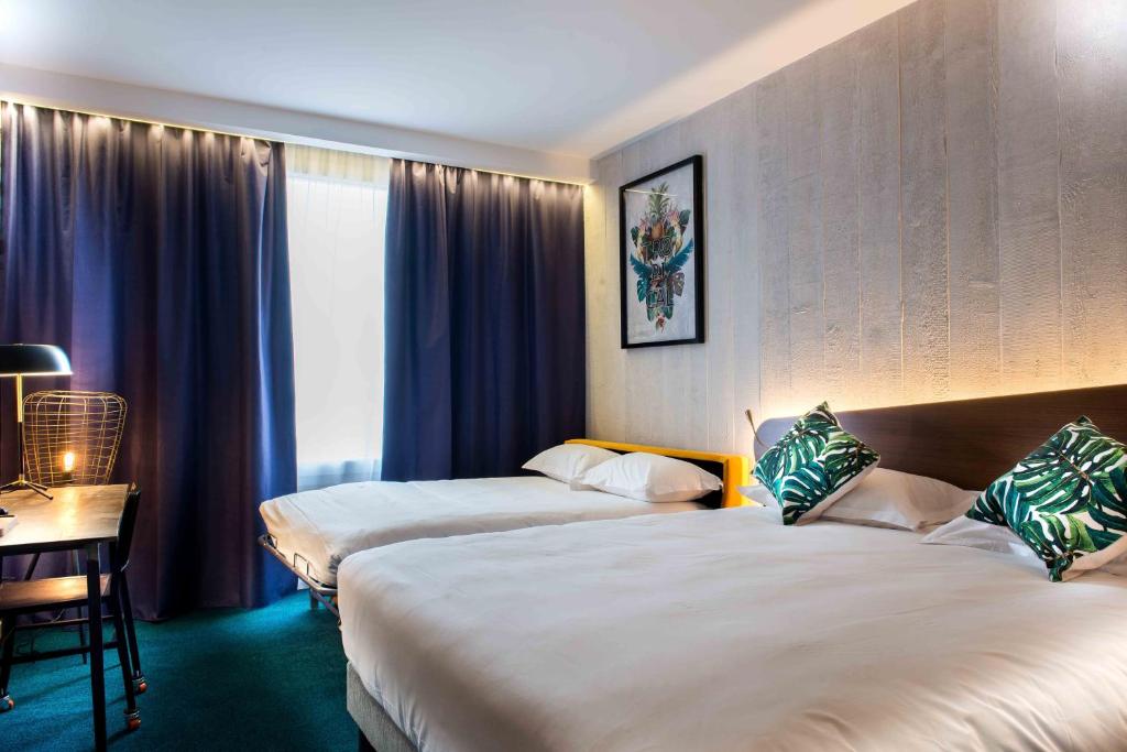 Postel nebo postele na pokoji v ubytování KOPSTER Hotel Lyon Groupama Stadium