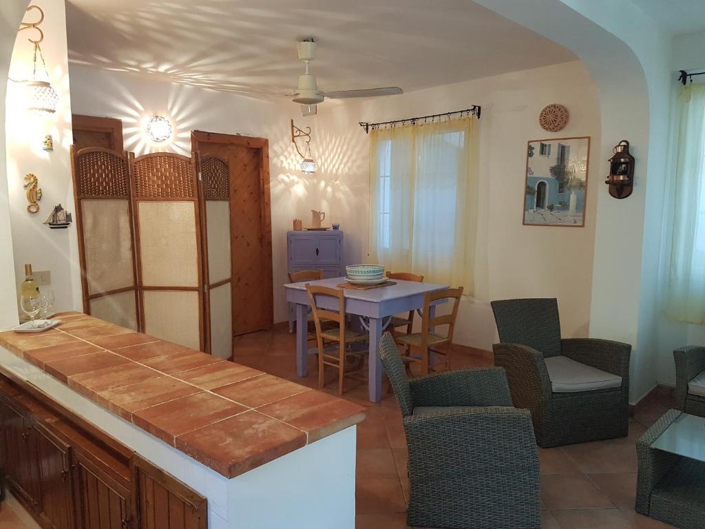a kitchen and dining room with a table and chairs at Casa Vacanze Marausa Birgi KITE in Marausa