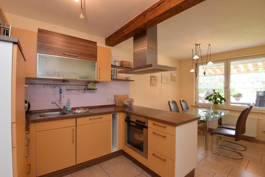 a kitchen with a sink and a table in it at Ferienwohnung Schulze in Ilmtal