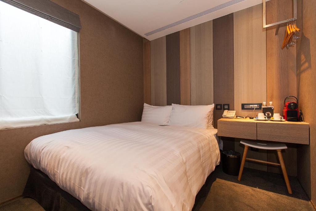 Postel nebo postele na pokoji v ubytování Hotel East Taipei