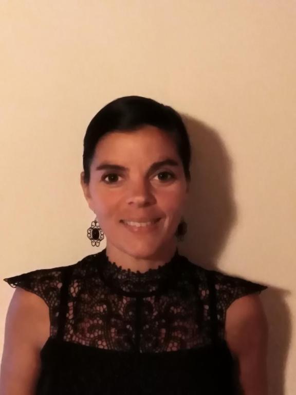 a woman in a black dress posing for a picture at Entre mûres et châtaignes in Les Châtelliers-Châteaumur