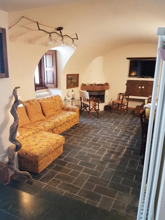 a living room with a couch and a piano at BORMIO Centro storico in Bormio