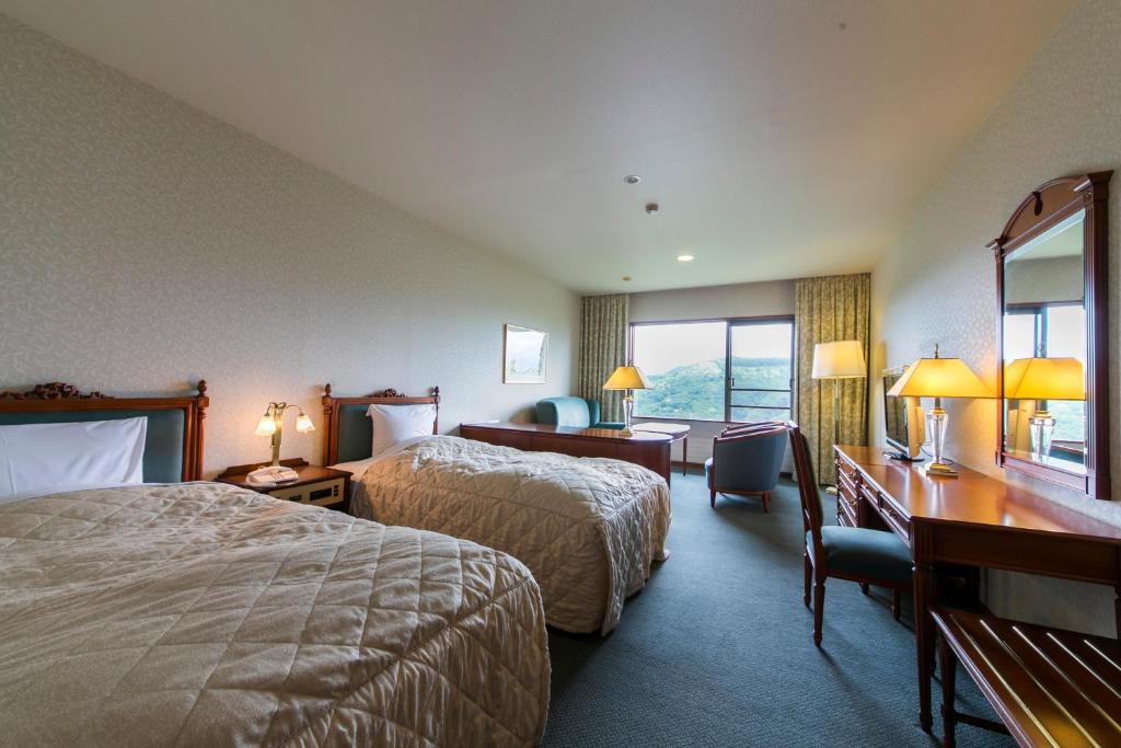 Postel nebo postele na pokoji v ubytování Sky Park Hotel