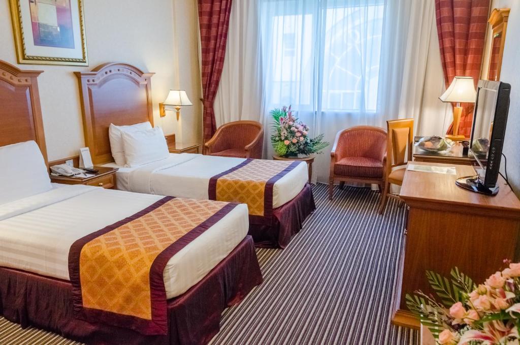 Postel nebo postele na pokoji v ubytování Avenue Hotel Dubai