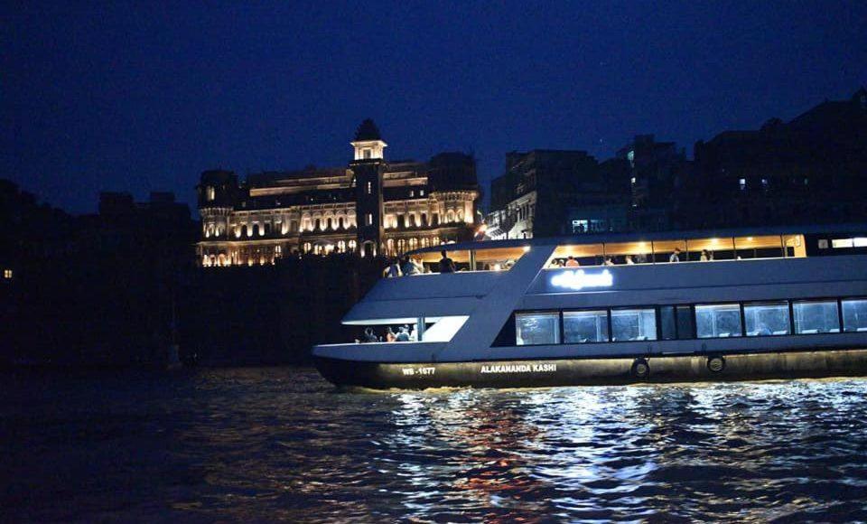 a large boat in the water at night at Ashiyana Hotel in Varanasi