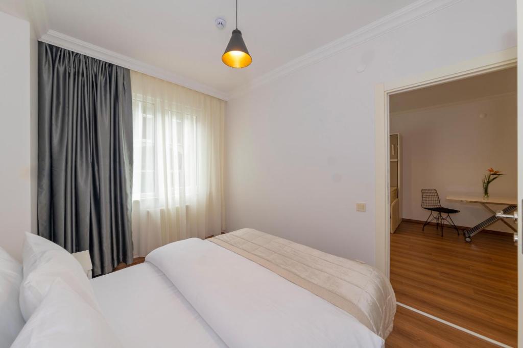 Postel nebo postele na pokoji v ubytování Joy Suites