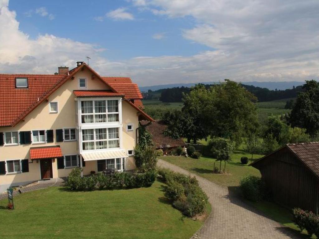 una grande casa con un cortile verde davanti di Ferienwohnung Stapelfeldt a Wasserburg