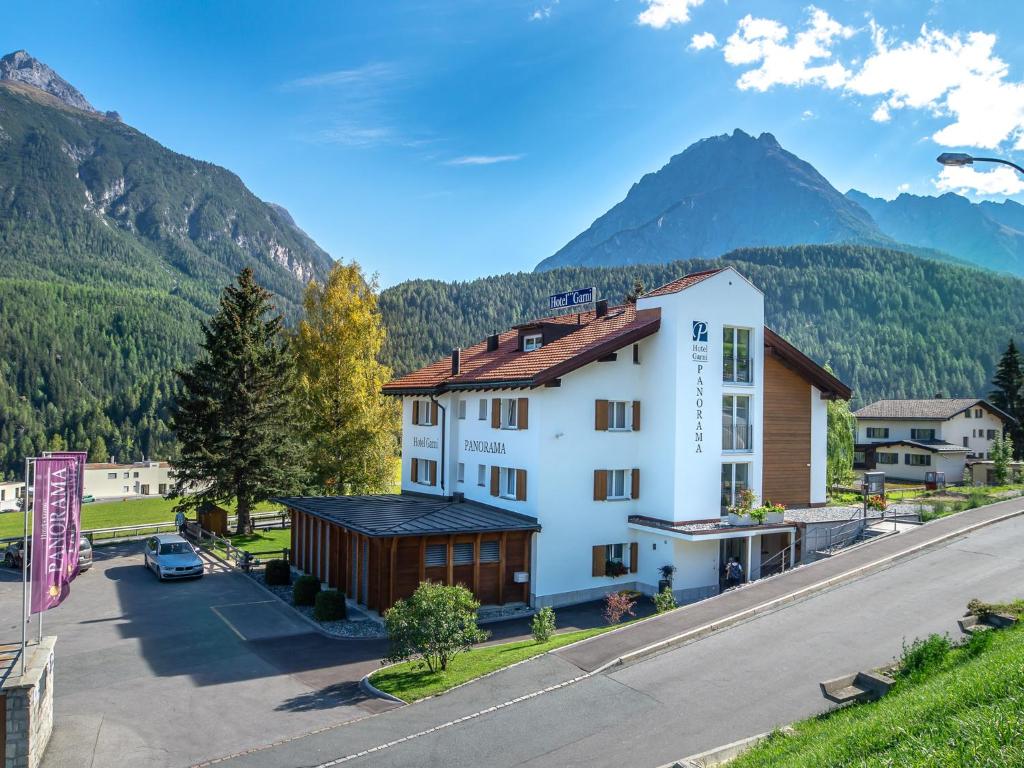 an aerial view of a hotel with mountains in the background at Hotel Garni Panorama in Scuol