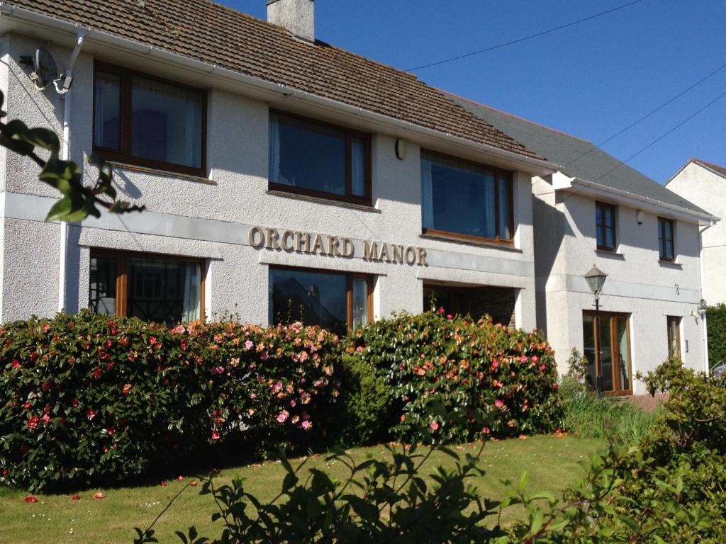 an office building with flowers in front of it at Orchard Manor in Probus