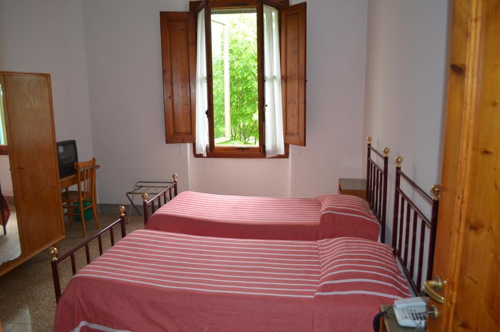 Postel nebo postele na pokoji v ubytování Albergo Padellino