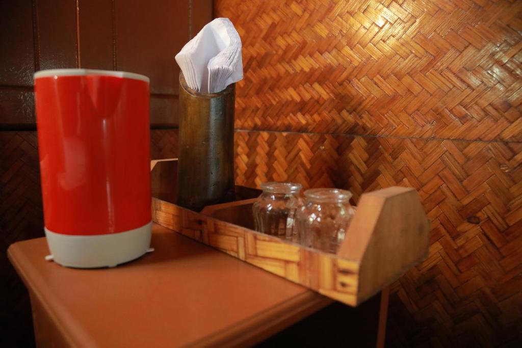 a red cup sitting on top of a table at Sajeev Home Stay in Cherai Beach