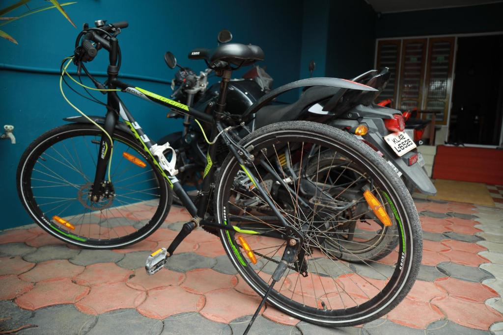 a bike is parked next to a motorcycle at Sajeev Home Stay in Cherai Beach