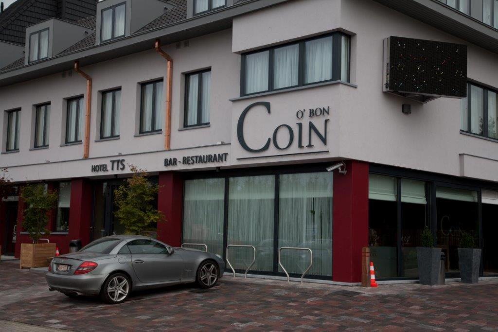 a car parked in front of a building at Hotel TTS in Temse