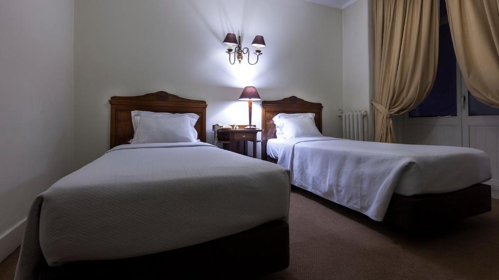 Postel nebo postele na pokoji v ubytování Hotel Astoria