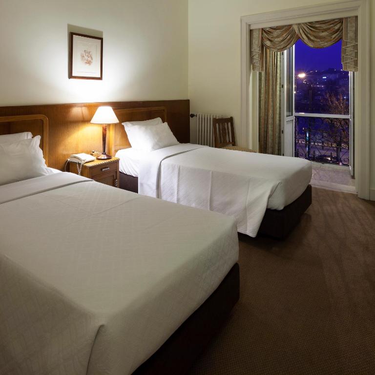 Postel nebo postele na pokoji v ubytování Hotel Astoria