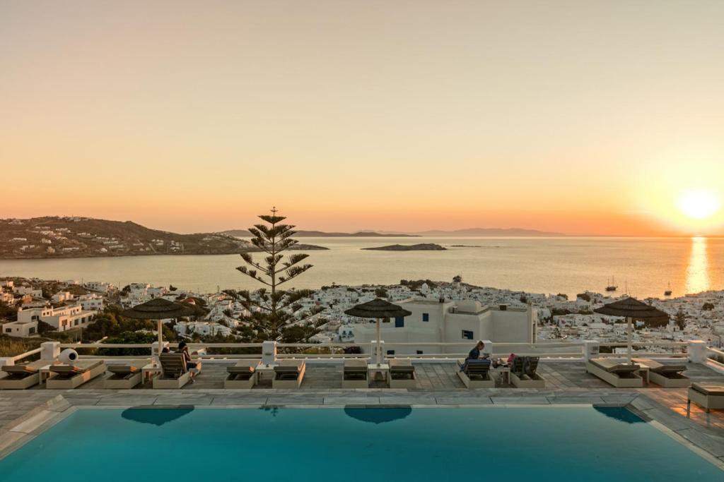 a resort with a pool and a view of the ocean at Hotel Alkyon in Mikonos