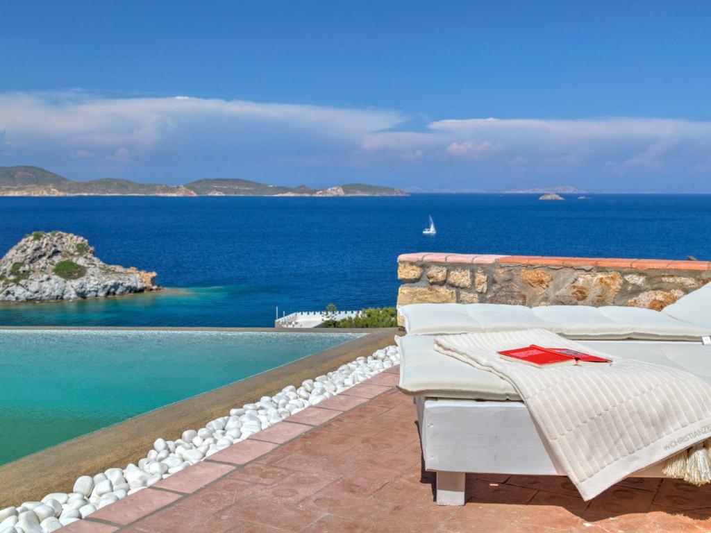 a resort with a pool and a view of the ocean at Eirini Luxury Hotel Villas in Grikos