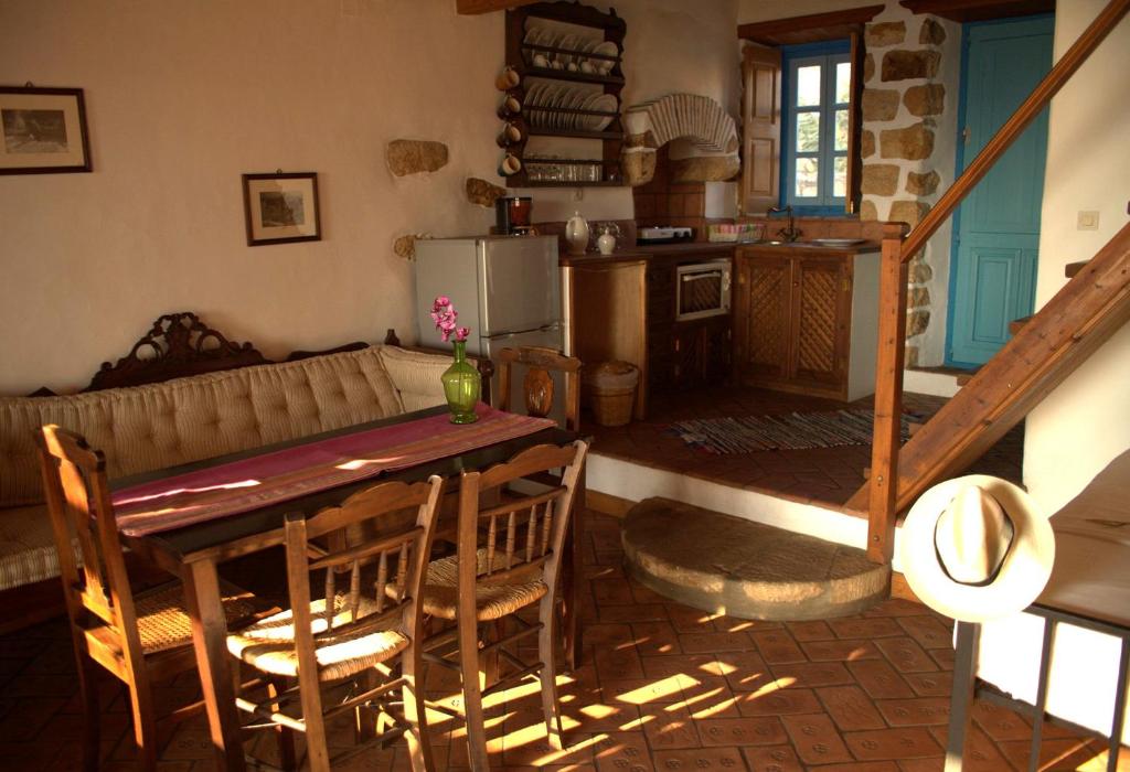 a kitchen and living room with a table and chairs at Eirini Luxury Hotel Villas in Grikos