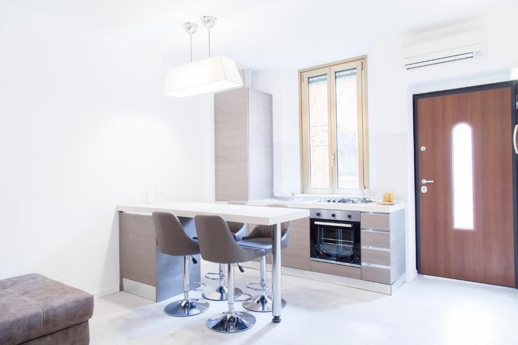 a kitchen with a table and chairs in a room at Brand, new and fully furnished apt in Milan