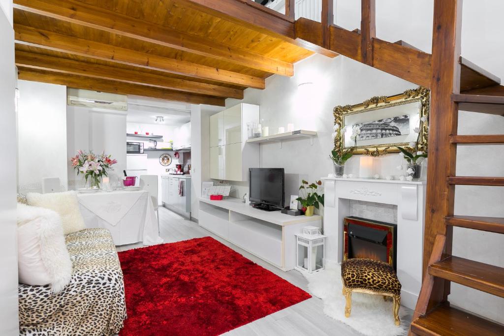 a living room with a fireplace and a red rug at Diana Luxury Loft in Rome