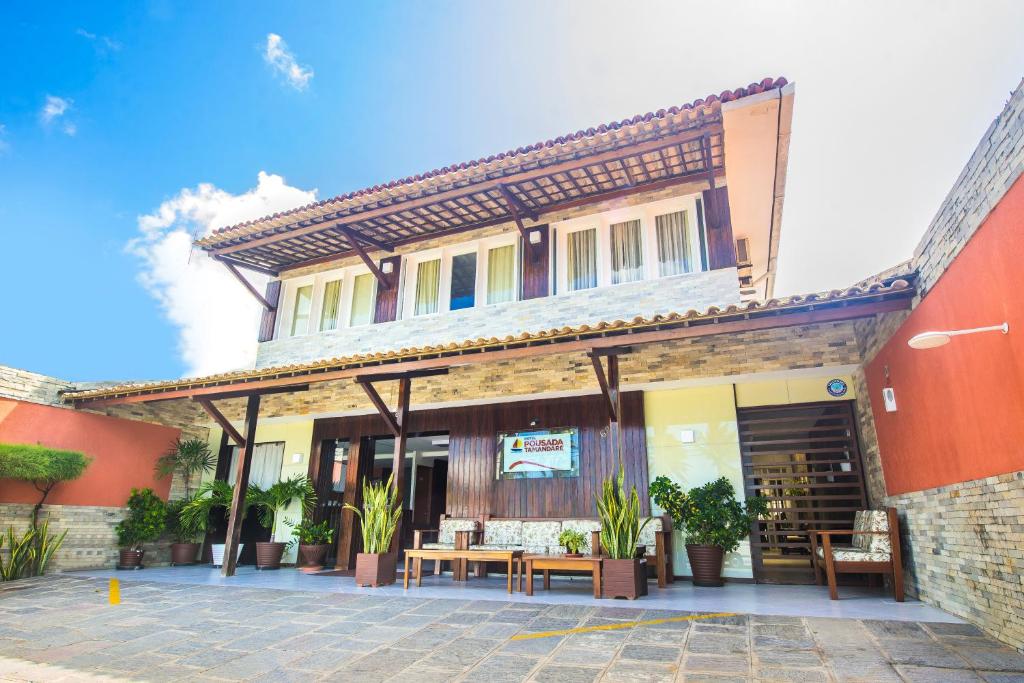 a building with a patio in front of it at Hotel Pousada Tamandaré - PB in João Pessoa