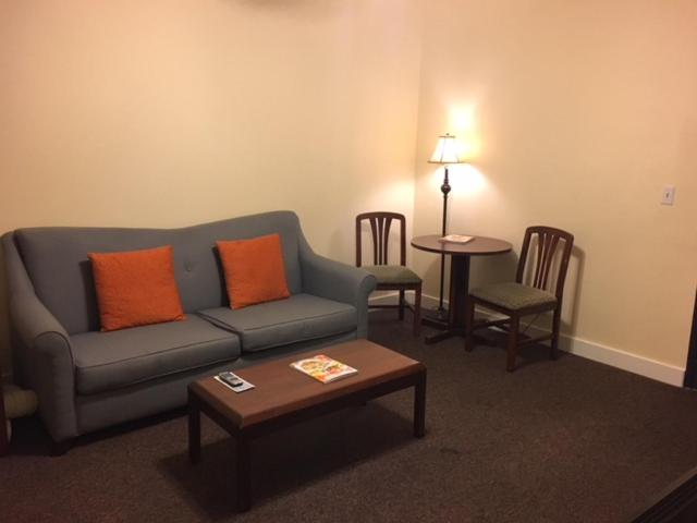 a living room with a couch and chairs and a table at Washington Plaza - Portland in Portland