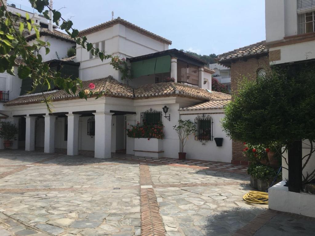 ラ・エラドゥーラにあるEl Palomar de La Herraduraの石造りの中庭がある大きな白い家