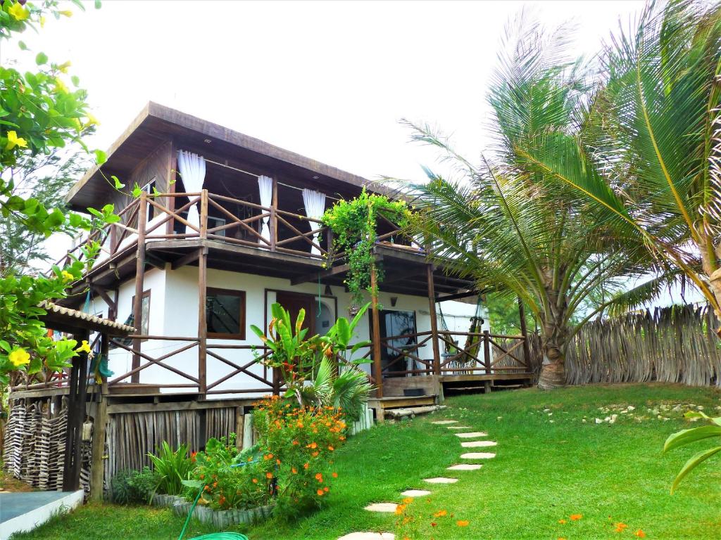 a house with a garden in front of it at The Spot - Beachfront Sports Pousada in Icaraí