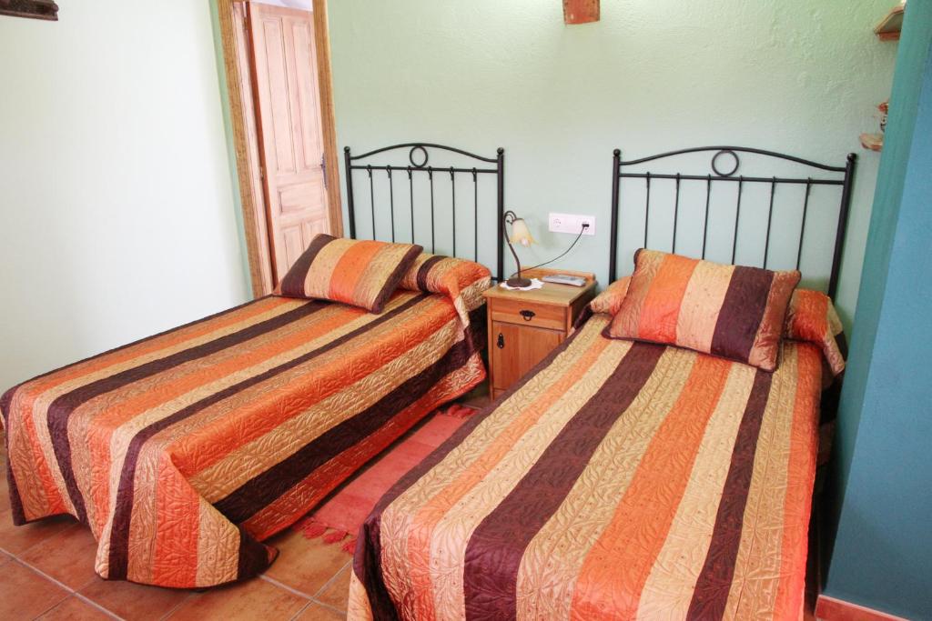 Postel nebo postele na pokoji v ubytování Hotel Rural Valle del Tuejar