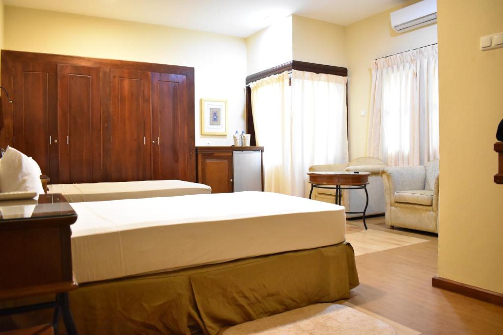 Postel nebo postele na pokoji v ubytování Hotel 4 U Saliya Garden