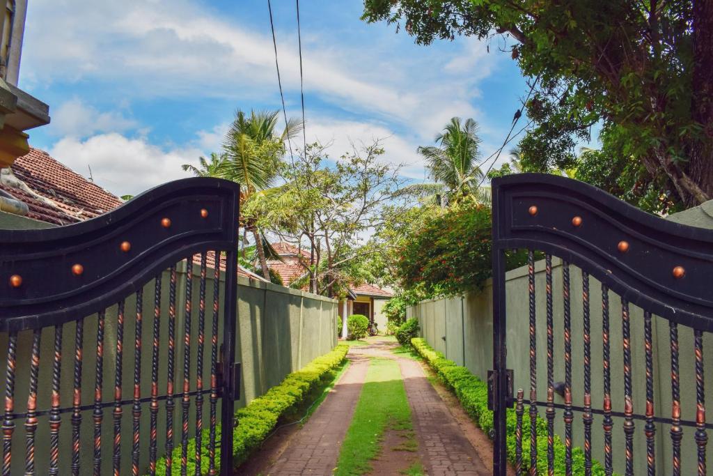 a gate to a house with a driveway at Agasthi Airport Close in Katunayaka