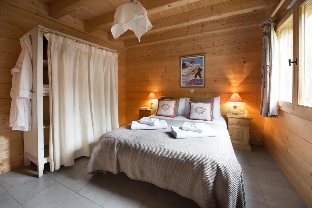 a bedroom with a bed with towels on it at Chalet La Pastorale in Morzine