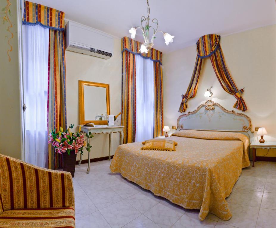 1 dormitorio con 1 cama y 1 silla en Hotel Henry, en Venecia