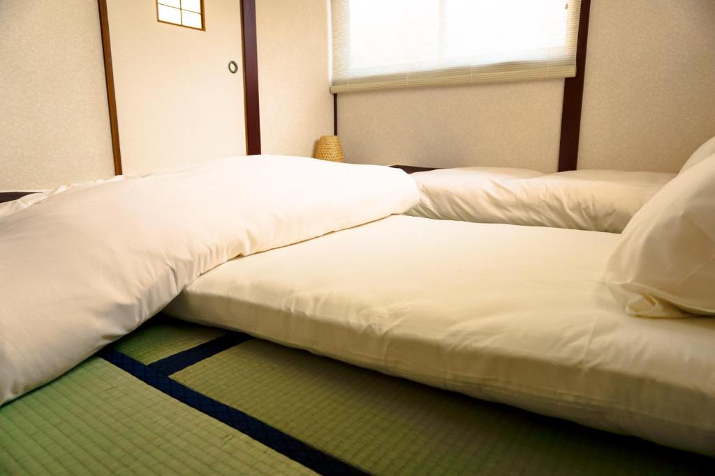 two beds sitting next to each other in a room at City Hotel Universal Studios Japan in Osaka