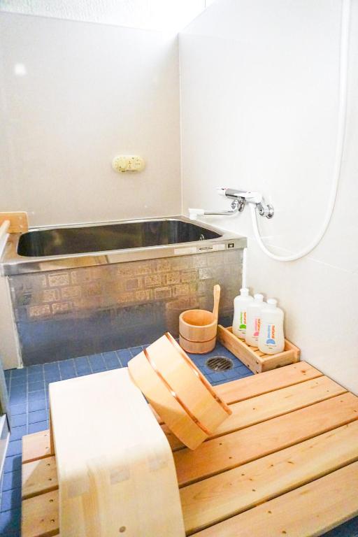 a bathroom with a tub and a wooden floor at City Hotel Universal Studios Japan in Osaka