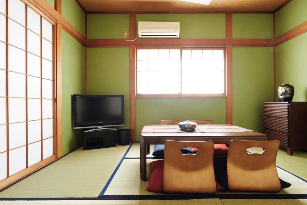 a living room with a table and a tv at City Hotel Universal Studios Japan in Osaka