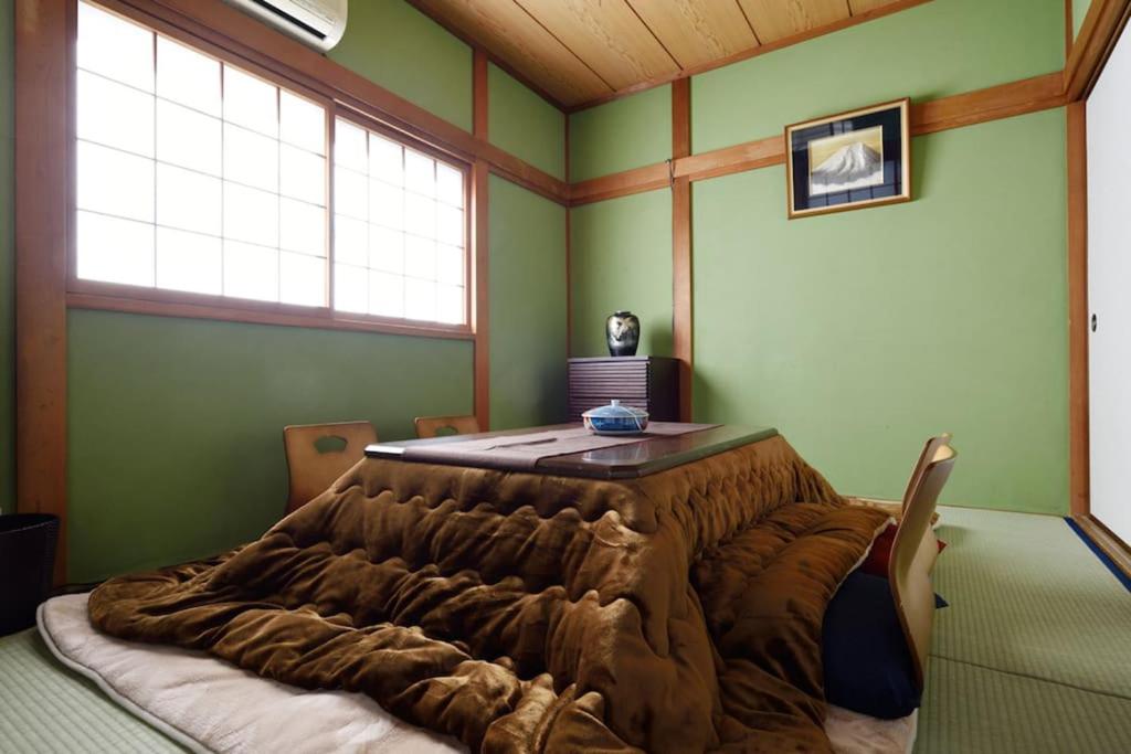a bedroom with a large bed in a room with green walls at City Hotel Universal Studios Japan in Osaka