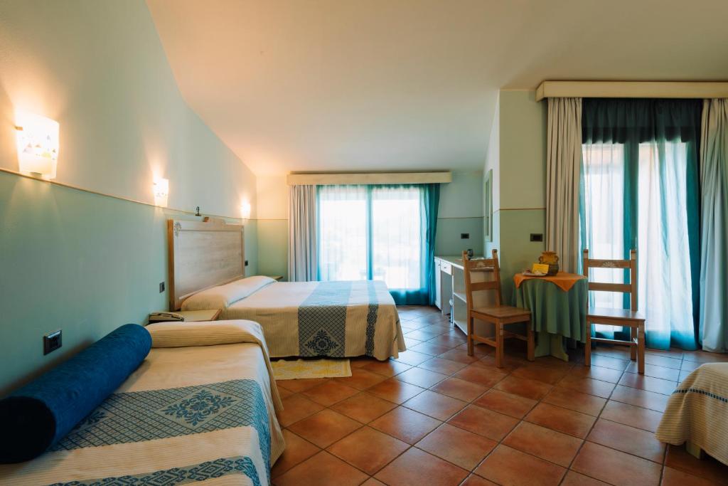 Postel nebo postele na pokoji v ubytování Hotel Luci Del Faro